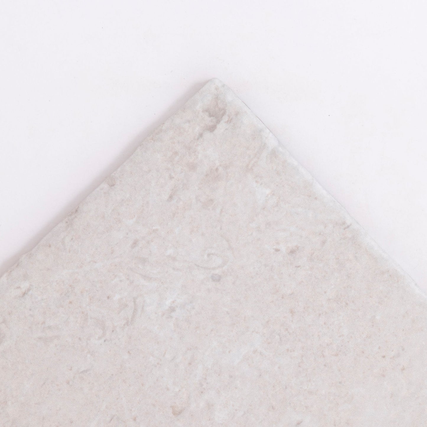 A close-up of the corner of Toba Multicolor R11 tile by Toba, showing its textured surface against a white background.