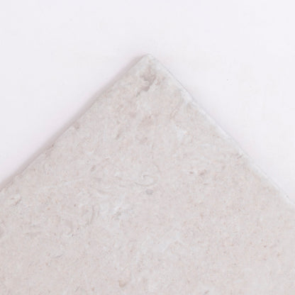 A close-up of the corner of Toba Multicolor R11 tile by Toba, showing its textured surface against a white background.