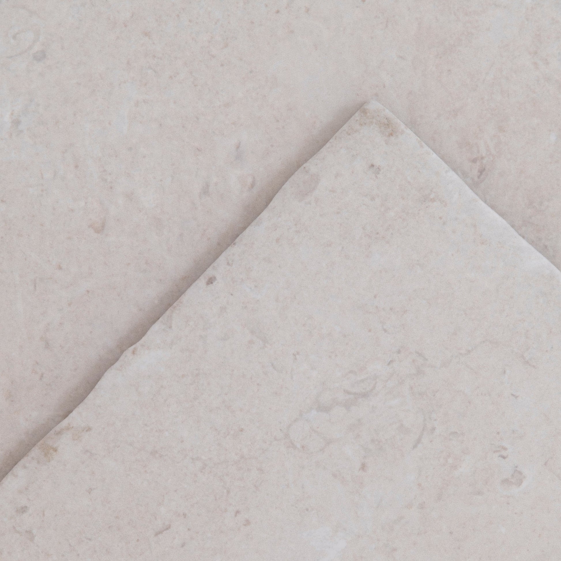 The Toba Multicolor R11 tile is placed diagonally on top of another tile with a similar color and texture.