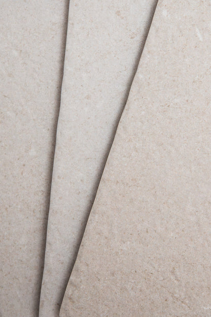 Close-up of two Toba Multicolor R11 sheets by Toba, featuring overlapping beige textured surfaces.