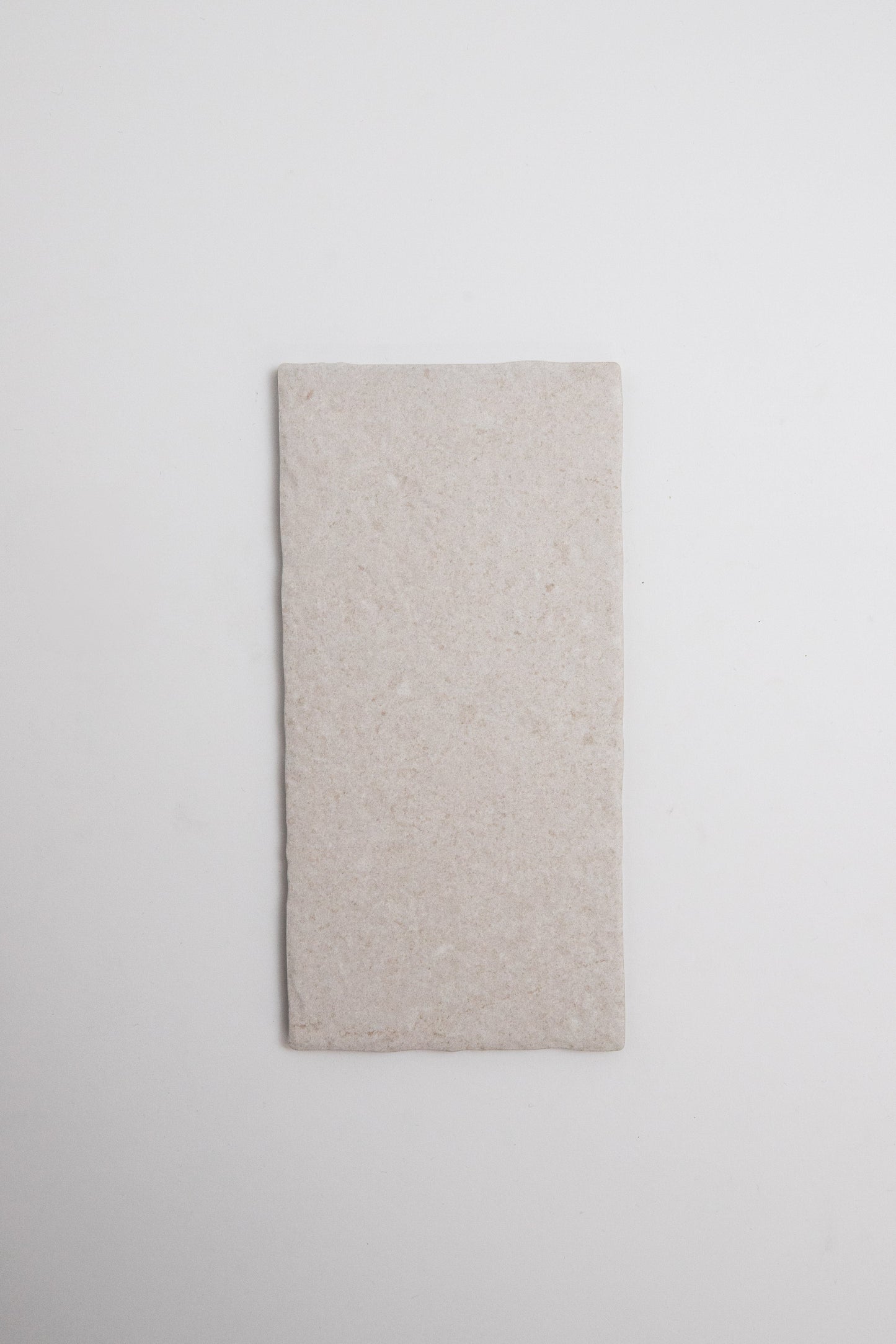The Toba Multicolor R11 by Toba is a rectangular, lightly textured tile in light beige on a white background.