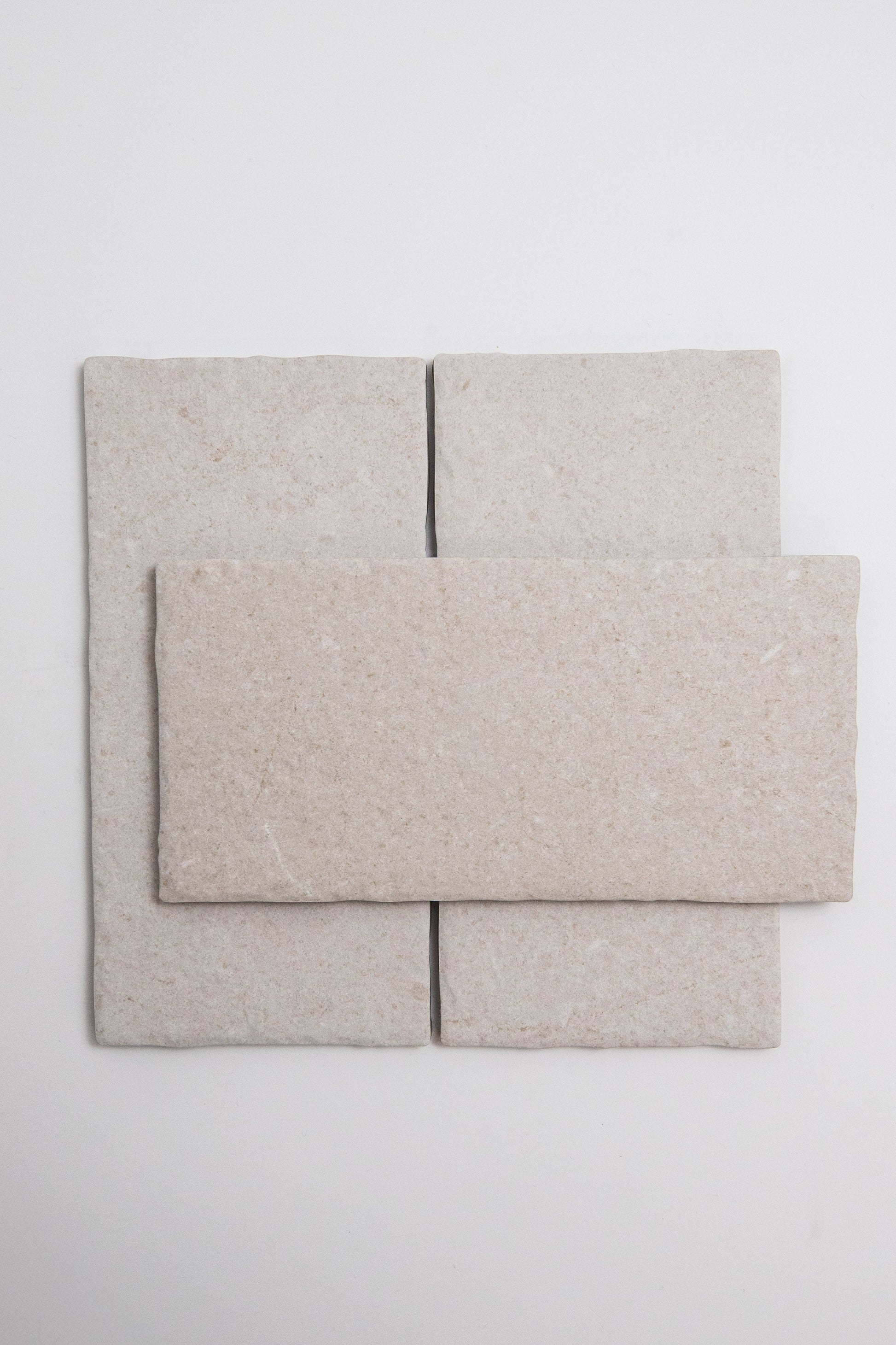 Three Toba Multicolor R11 tiles—two vertical side by side, one horizontal on top—are arranged in light beige.