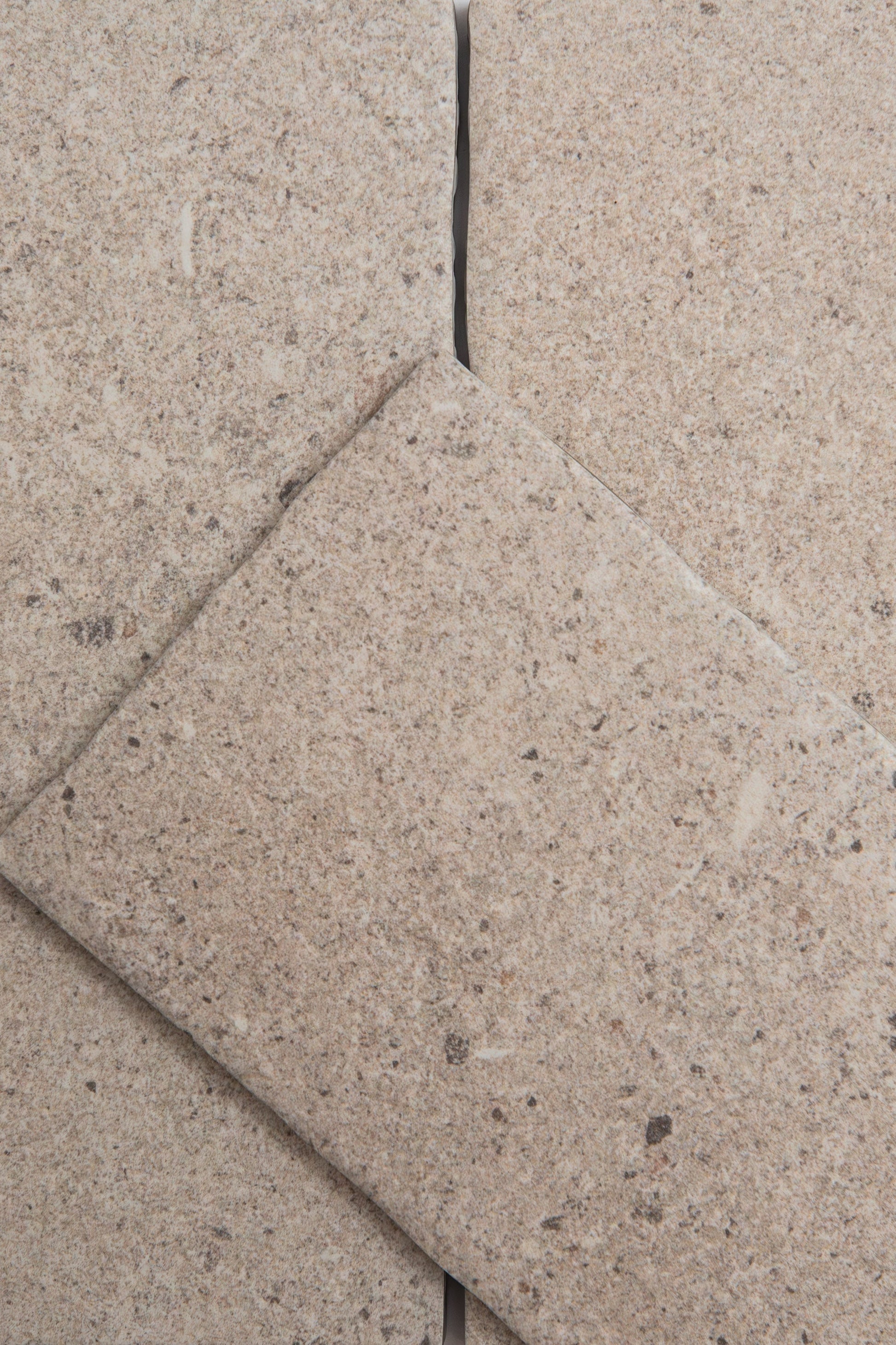 Close-up of Toba Taupe R11 tiles by Toba arranged diagonally with visible grout lines.