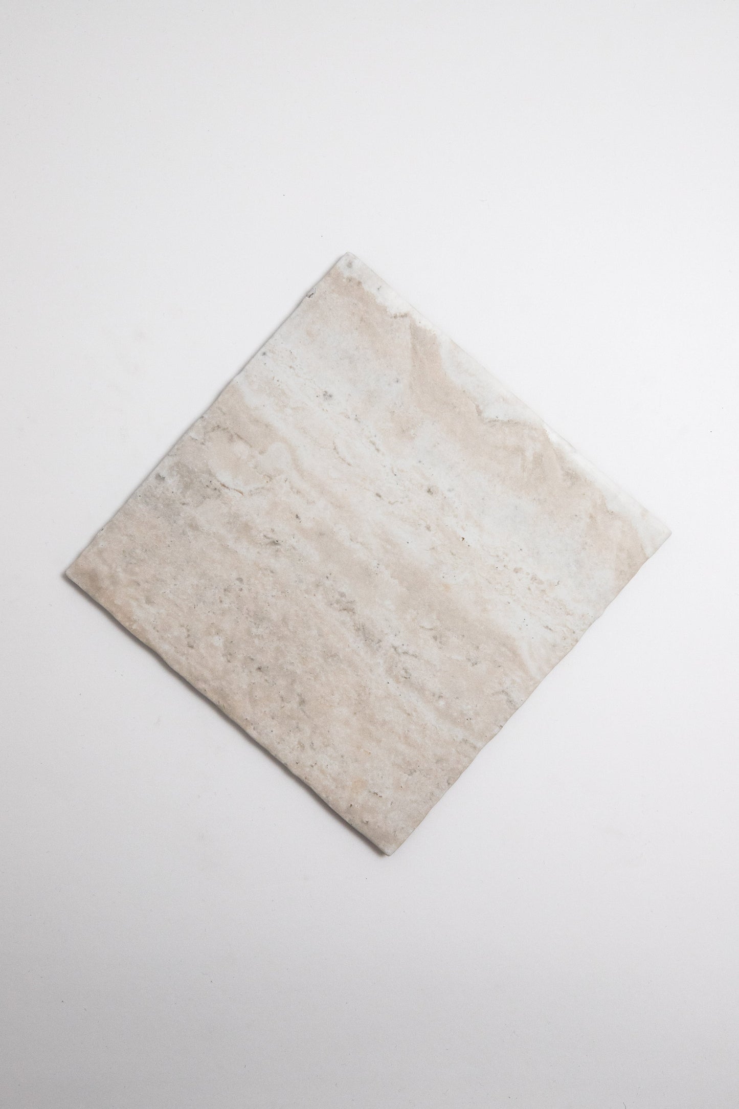 A single Tosca Travertine rectangular beige tile placed diagonally on a plain white background.