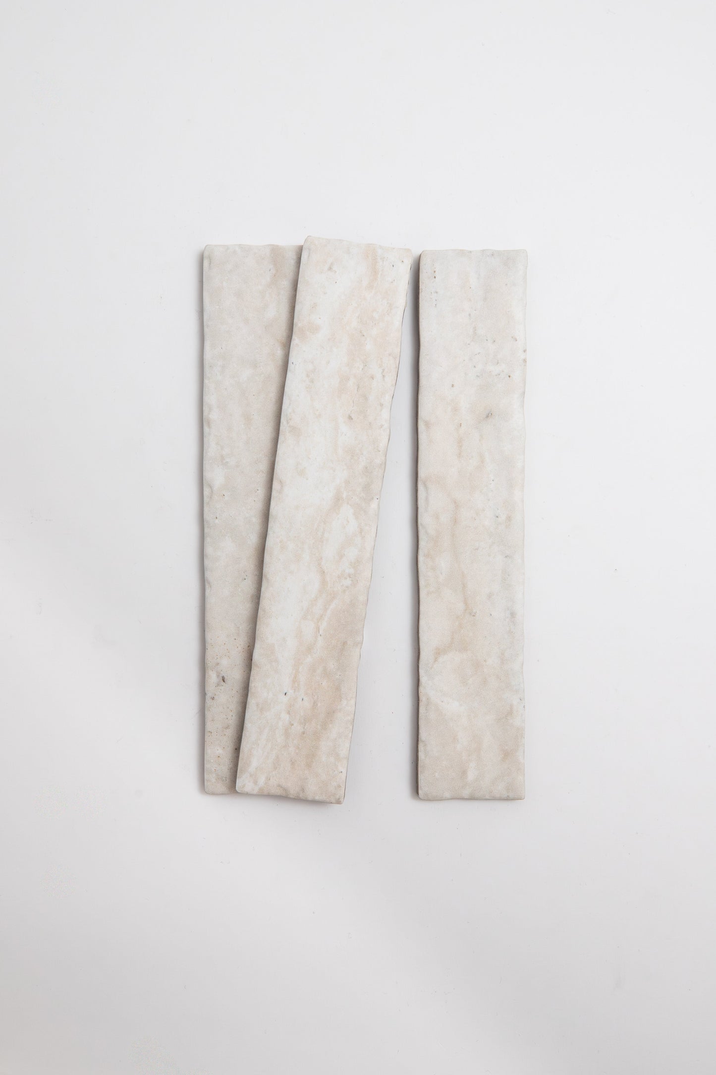 Three Tosca Travertine rectangular beige tiles displayed vertically on a plain white background.