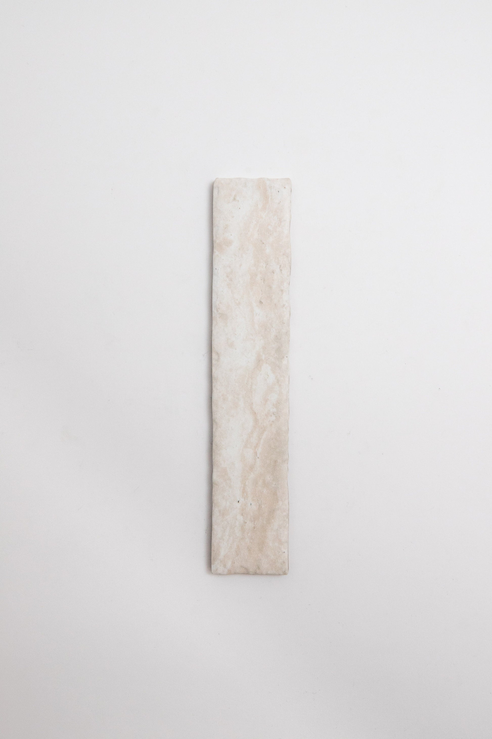 The Tosca Travertine tile is rectangular, light beige with subtle marbling, shown vertically on a white background.