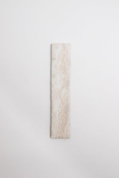 The Tosca Travertine tile is rectangular, light beige with subtle marbling, shown vertically on a white background.