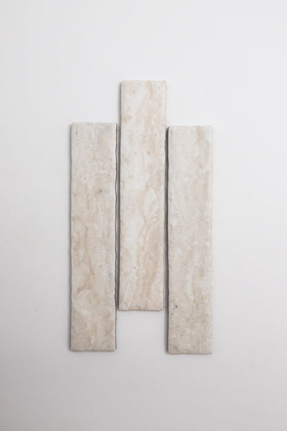 Three Tosca Travertine rectangular beige tiles arranged vertically on a plain white background.