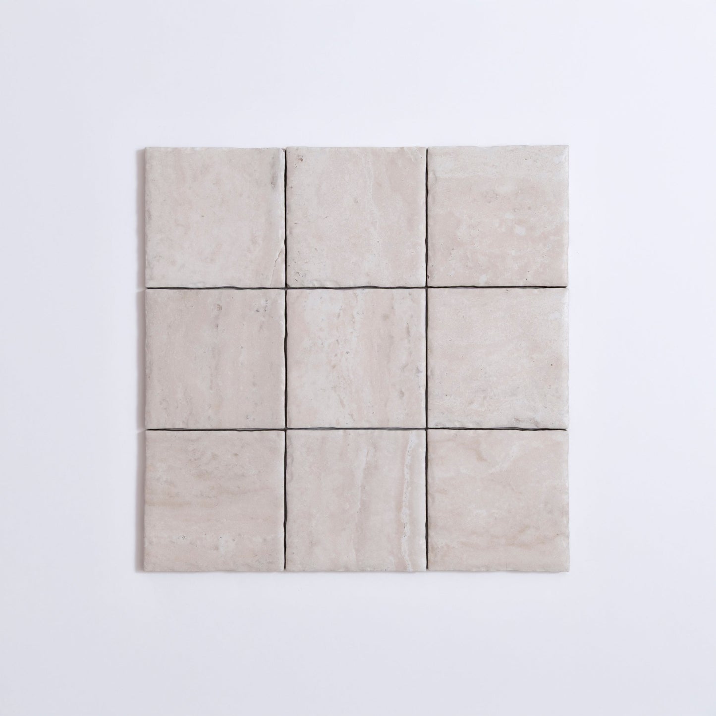 Nine Tosca Travertine tiles in a 3x3 grid on a plain white background.