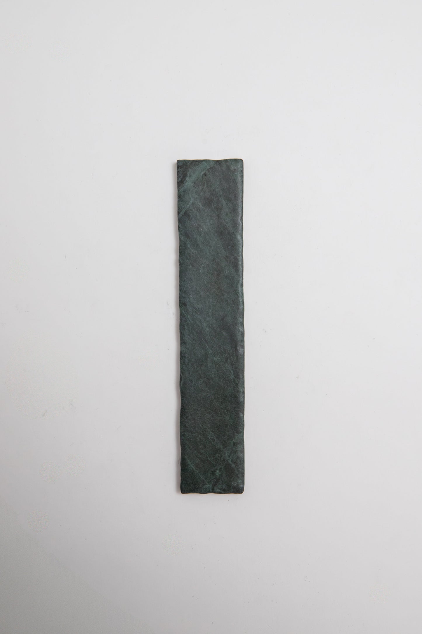 A rectangular Verde Tia marble sample by Tosca, in dark green, displayed on a plain white background.