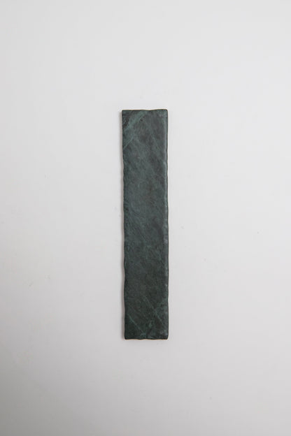 A rectangular Verde Tia marble sample by Tosca, in dark green, displayed on a plain white background.