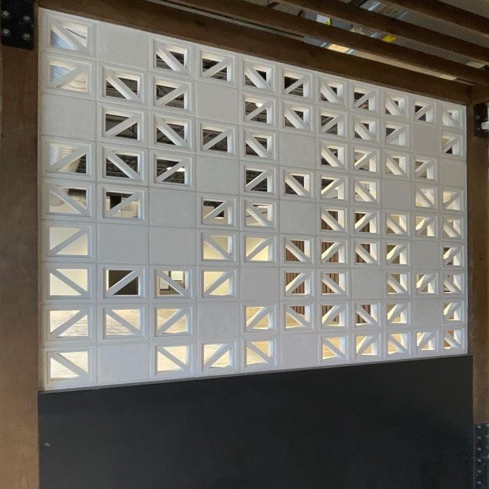 The Windy Sixty-Five by New York Cement Tile features open and solid white blocks in a mid-century geometric design.