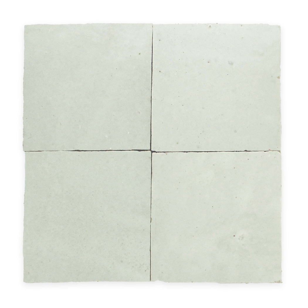 Four light grey square tiles arranged in a 2x2 grid with slight gaps between them.