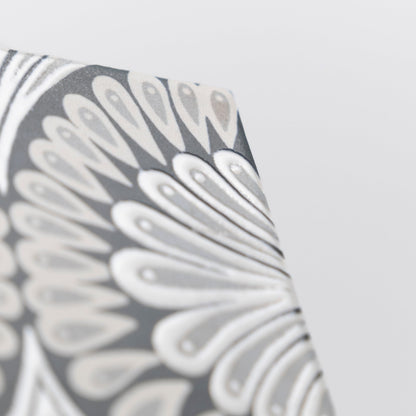 Close-up of Cottage Ivy Zoe Deco sample featuring a gray and white abstract floral pattern on a textured surface.